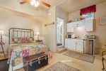 Main level studio suite with a queen bed, kitchenette, bathroom, and more